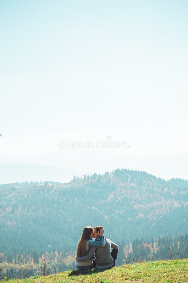 Some Couple travelers Boys and Girls sitting on cliff happy emotions Lifestyle concept Young family traveling active royalty free stock photos Some Couple travelers Boys and Girls sitting on cliff happy emotions Lifestyle concept Young family traveling active royalty free stock photos