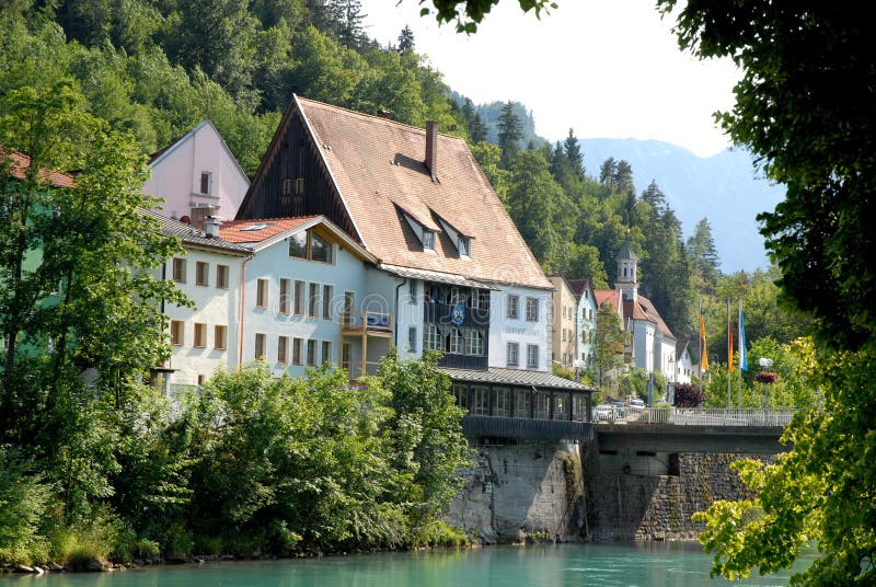 Some houses and a church beyond the river in the town of Fussen in Bavaria (Germany)