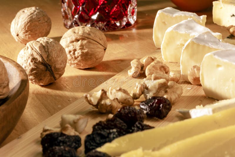 Some kinds of cheeses, nuts and apricot and raisins at the morning. Some kinds of cheeses, nuts and apricot and raisins at the morning