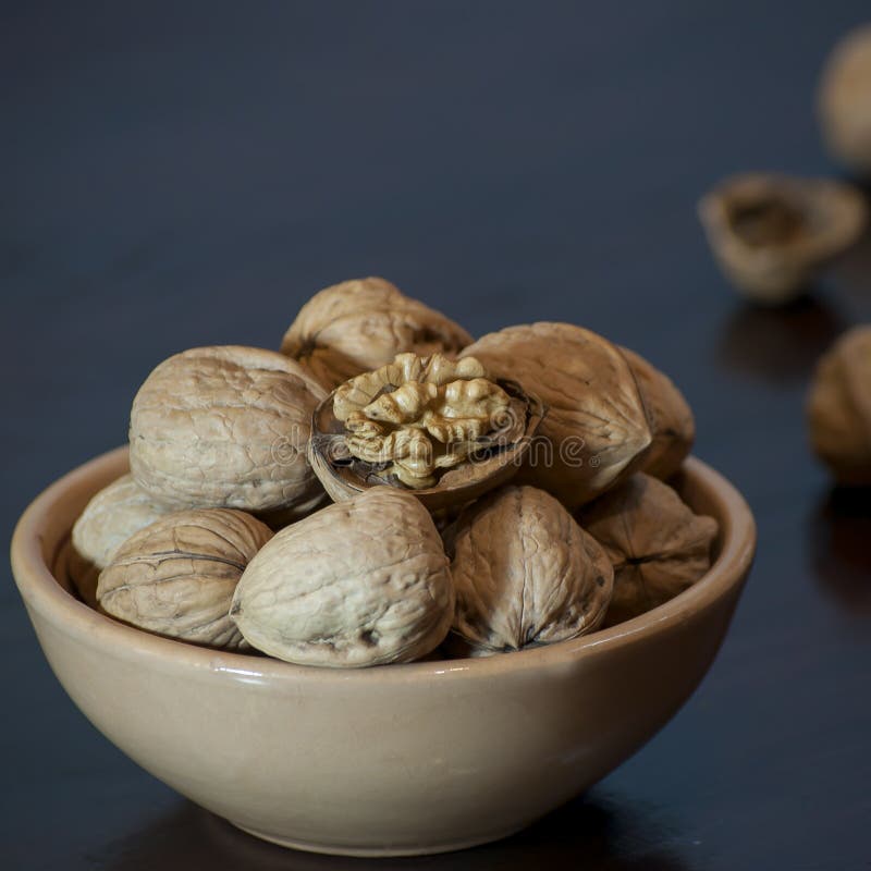 Some nuts in a container on the table. Some nuts in a container on the table