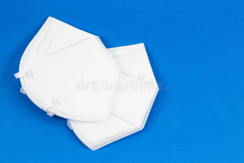 Some particle filtering half masks isolated on blue background stock photography
