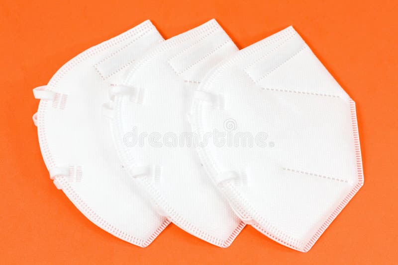 Some particle filtering half masks isolated on orange background