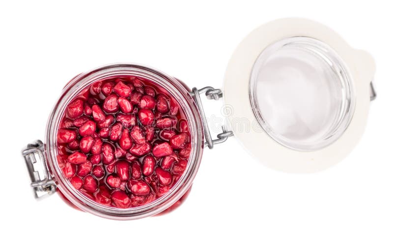 Portion of preserved Pomegranate seeds isolated on white background selective focus. Some preserved Pomegranate seeds isolated on white selective focus