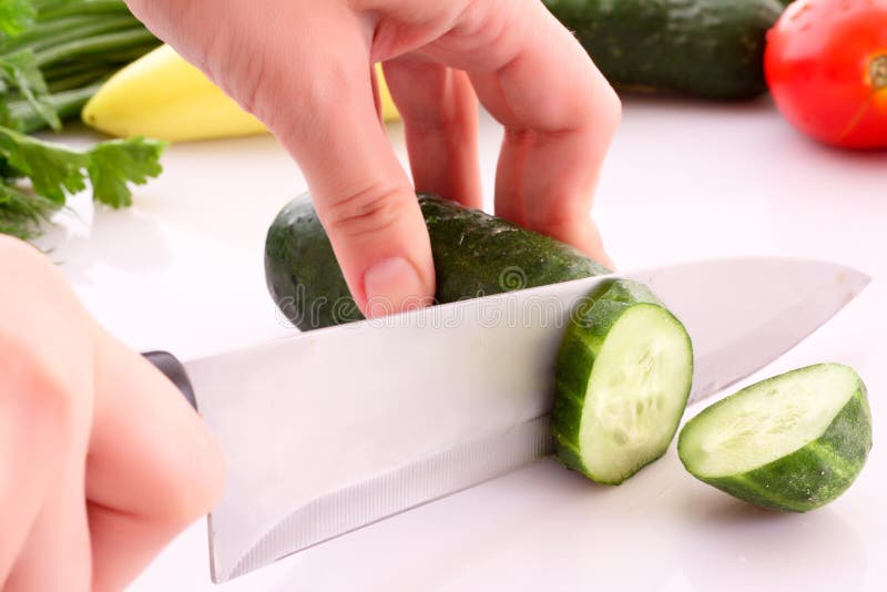 Someone cutting a cucumber stock image. Image of slice - 10668577