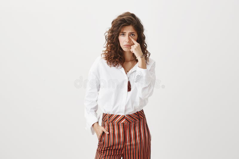 Someone made poor girl cry. Unhappy upset attractive and cute female with curly hair, frowning and sulking, crying royalty free stock photos Someone made poor girl cry. Unhappy upset attractive and cute female with curly hair, frowning and sulking, crying royalty free stock photos
