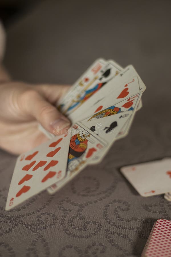 Someone playing with cards on a table stock photography