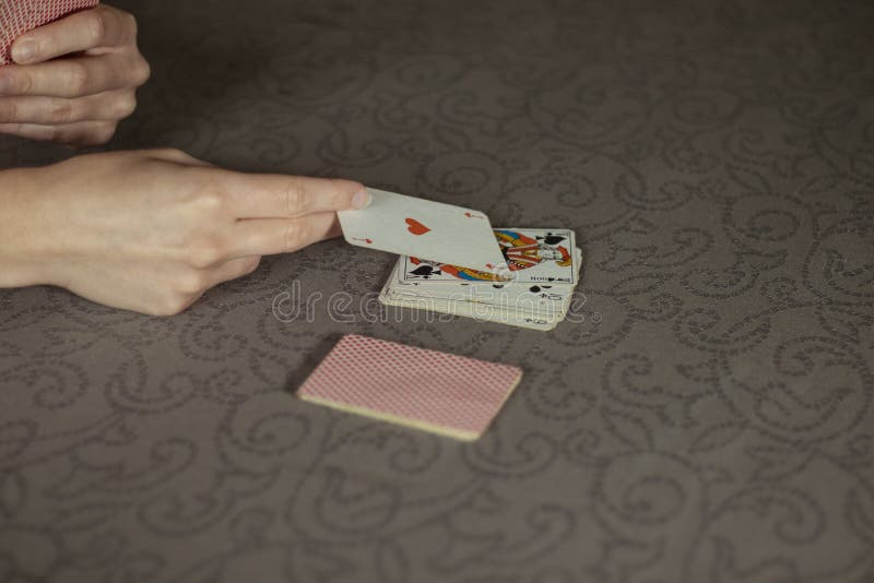 Someone playing with cards on a table stock photography