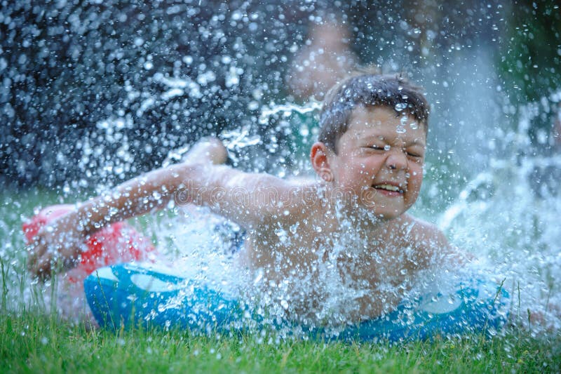 Tween boy sliding on summer slide. Tween boy sliding on summer slide