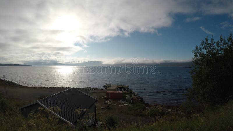 Sommersonnenuntergang über blauer Fjordlandschaft in Nord-Norwegen