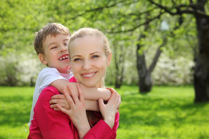 Son embraces behind mother for neck