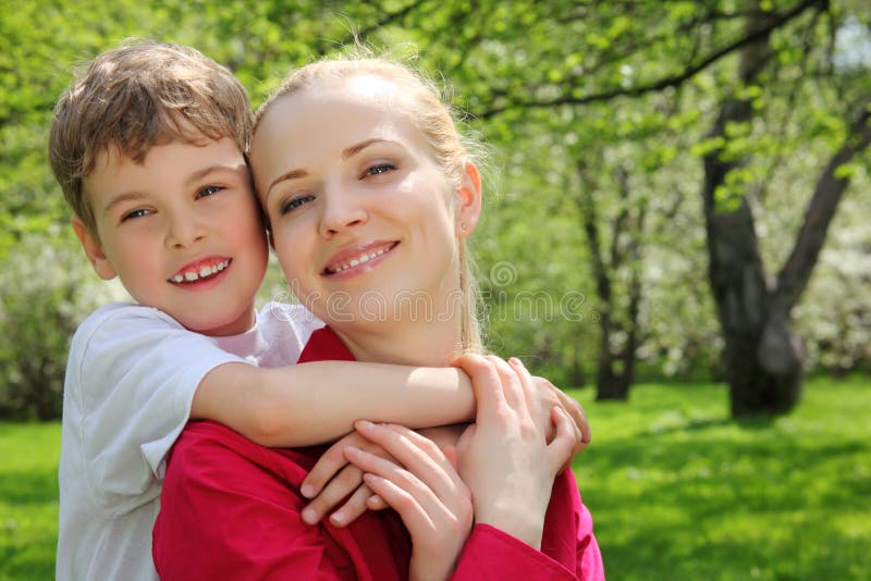 Son embraces behind mother for neck