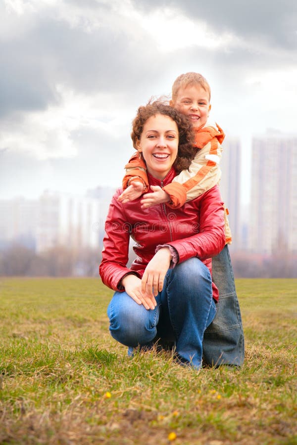 Son embraces mother from back