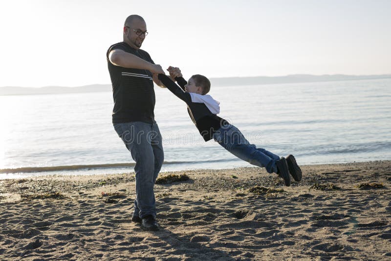 Son on Father Shoulders at the Beach Having Fun Sunset Together Stock ...