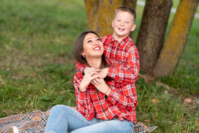 The Son Gently Hugs Mom On The Shoulders Both Smiling Happily Stock Image Image Of Natural 