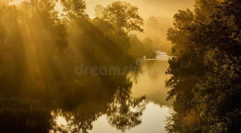Sunrise Over River with Sunrays Coming Through Trees. Sunrise Over River with Sunrays Coming Through Trees