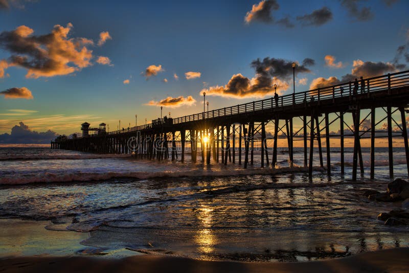 Sonnenuntergang am Ozeanufer-Pier lizenzfreies stockbild Sonnenuntergang am Ozeanufer-Pier lizenzfreies stockbild