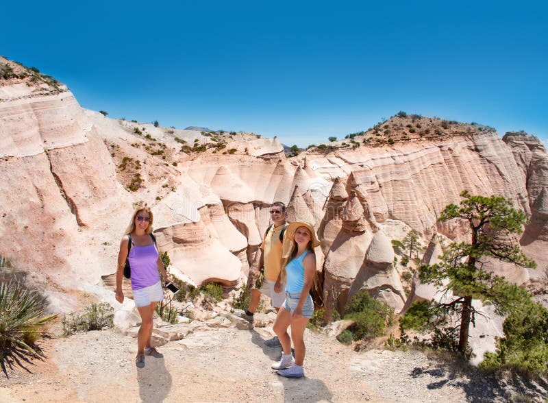 Smiling , happy family on hiking trip in beautiful mountains.Kasha-Katuwe Tent Rocks National Monument, Close to of Santa Fe, New Mexico, USA. Smiling , happy family on hiking trip in beautiful mountains.Kasha-Katuwe Tent Rocks National Monument, Close to of Santa Fe, New Mexico, USA