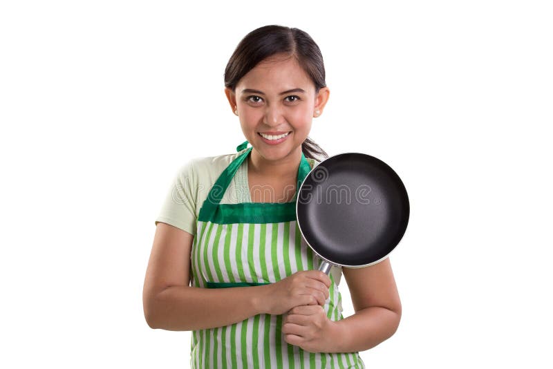 Sonrisas de cocinar confiadas de la señora imágenes de archivo libres de regalías Sonrisas de cocinar confiadas de la señora imágenes de archivo libres de regalías