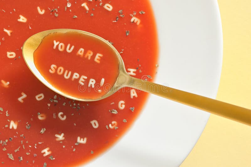 Tomato Soup With Letter Noodles On Spoon. Tomato Soup With Letter Noodles On Spoon