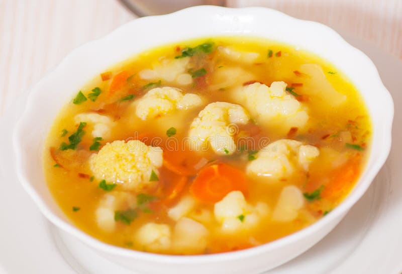 Fresh vegetable cauliflower soup on white plate. Fresh vegetable cauliflower soup on white plate