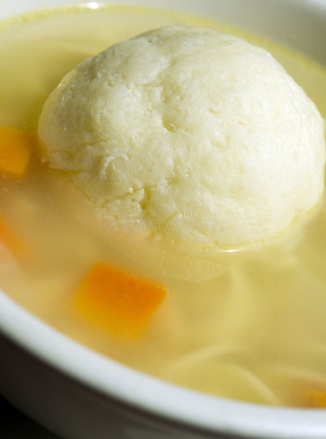 Bowl of matzoh ball soup with carrots and. Bowl of matzoh ball soup with carrots and