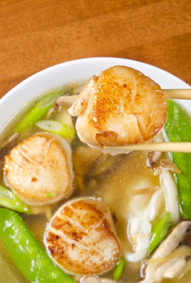 Noodles soup with pan seared scollops, snow peas, shiitake mushrooms, scallions, ginger and egg. Noodles soup with pan seared scollops, snow peas, shiitake mushrooms, scallions, ginger and egg.