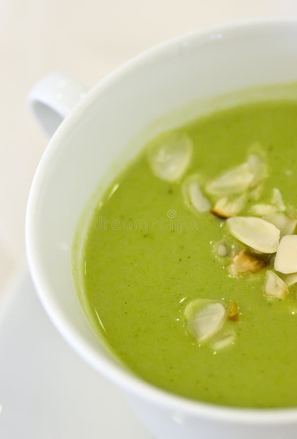 A green broccoli soup served in white bowl. A green broccoli soup served in white bowl.