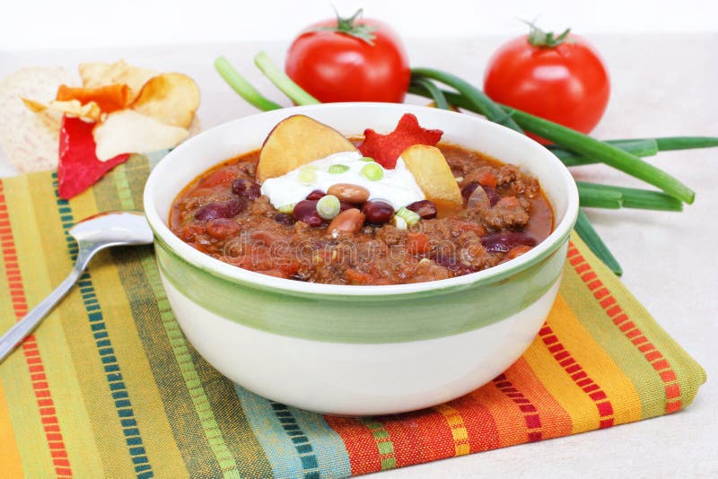 One bowl of Mexican Taco Soup, garnished with sour cream, scallions and vegetable chips. One bowl of Mexican Taco Soup, garnished with sour cream, scallions and vegetable chips.