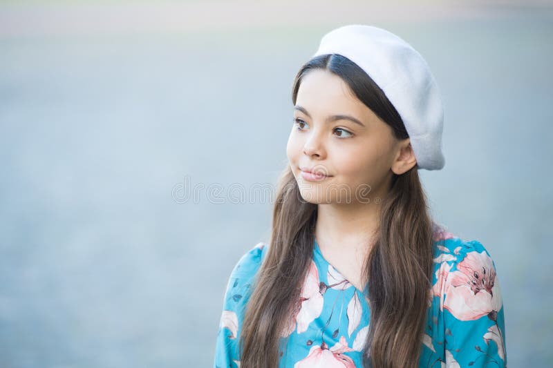 Sophisticated fashionista little girl wear beret hat and fancy dress, small parisian concept stock photo
