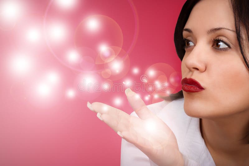 Attractive woman blowing in the wind isolated on red background. Attractive woman blowing in the wind isolated on red background