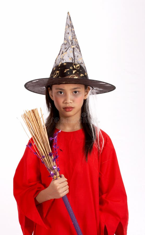 A young girl dressed in a witch costume. A young girl dressed in a witch costume