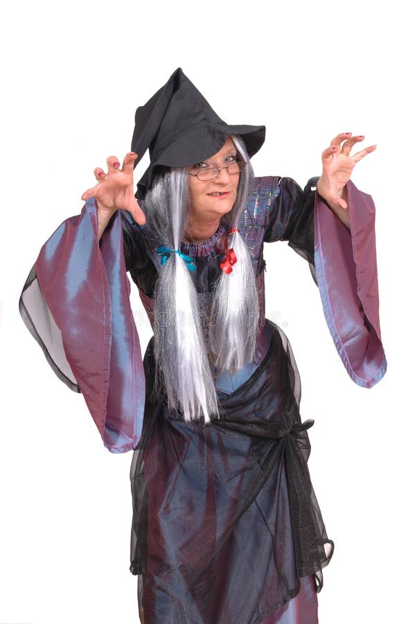 Halloween witch with scary expression, raised clawing hands, dressed up in costume. Halloween witch with scary expression, raised clawing hands, dressed up in costume