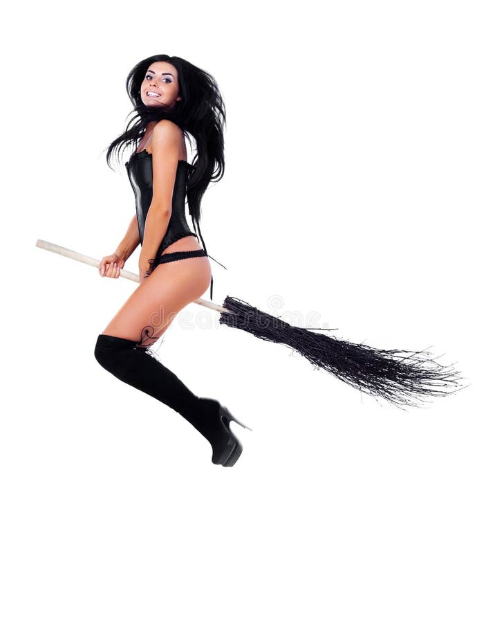 Pretty young brunette witch flying on a broom. Pretty young brunette witch flying on a broom