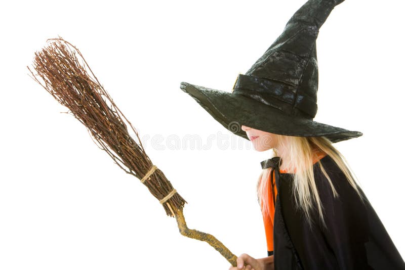 Photo of girl in witch costume holding broom. Photo of girl in witch costume holding broom