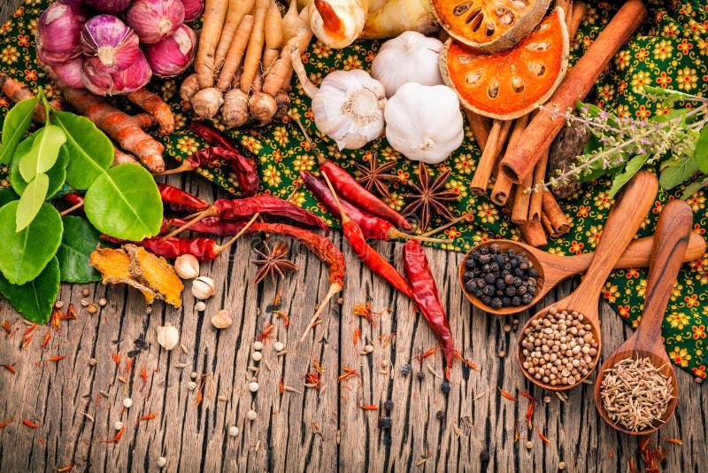 Assortment of Thai food Cooking ingredients .Red curry paste ingredients of thai popular food on rustic wooden background. Spices ingredients chili ,pepper, garlic,galangal and Kaffir lime leaves . Assortment of Thai food Cooking ingredients .Red curry paste ingredients of thai popular food on rustic wooden background. Spices ingredients chili ,pepper, garlic,galangal and Kaffir lime leaves .