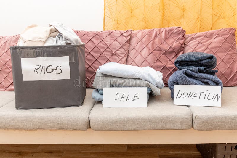 Sorting old clothes for sale, donations and rags, the concept of conscious consumption. Charity sorting stock images, royalty-free photos and pictures