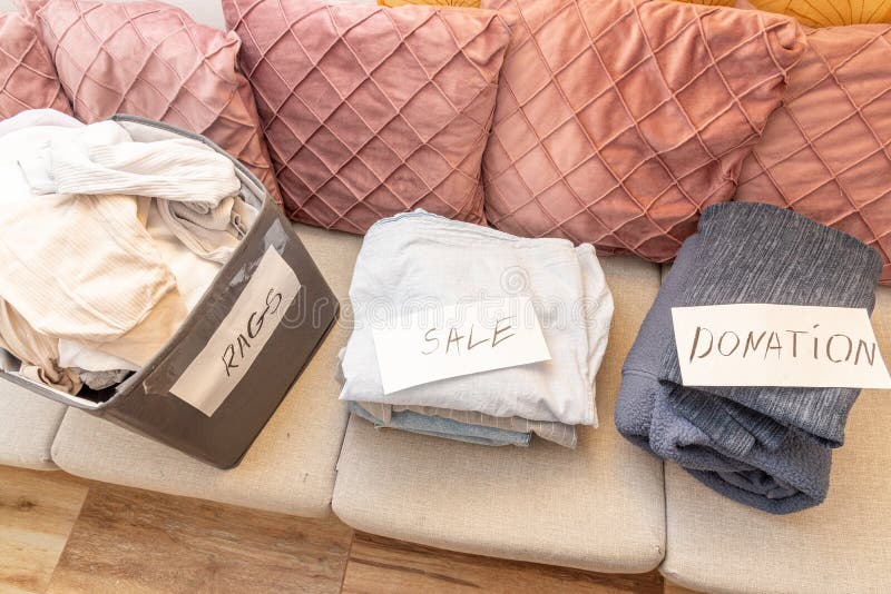 Sorting old clothes for sale, donations and rags, the concept of conscious consumption. Charity sorting stock images, royalty-free photos and pictures