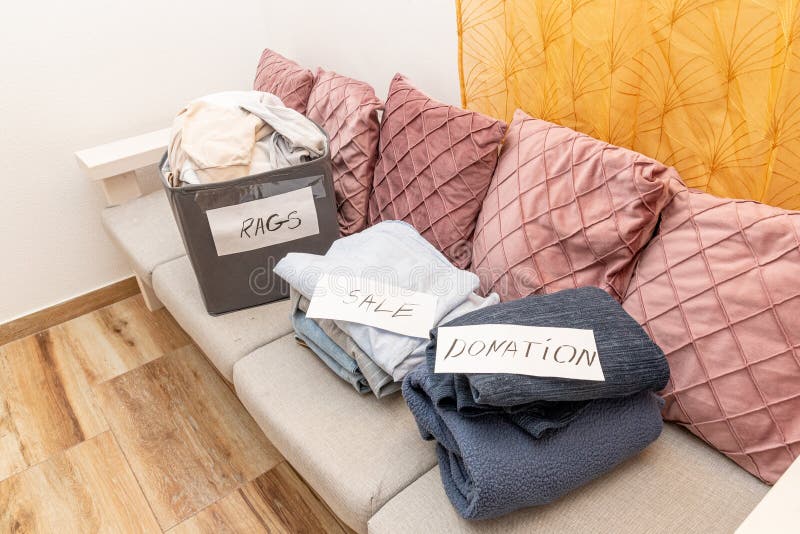 Sorting old clothes for sale, donations and rags, the concept of conscious consumption. Charity sorting stock images, royalty-free photos and pictures