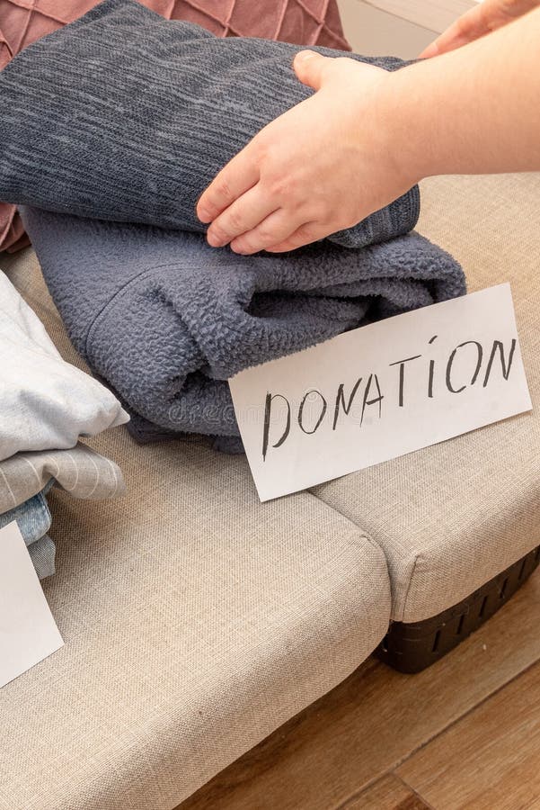 Sorting old clothes for sale, donations and rags, the concept of conscious consumption. Charity sorting stock images, royalty-free photos and pictures