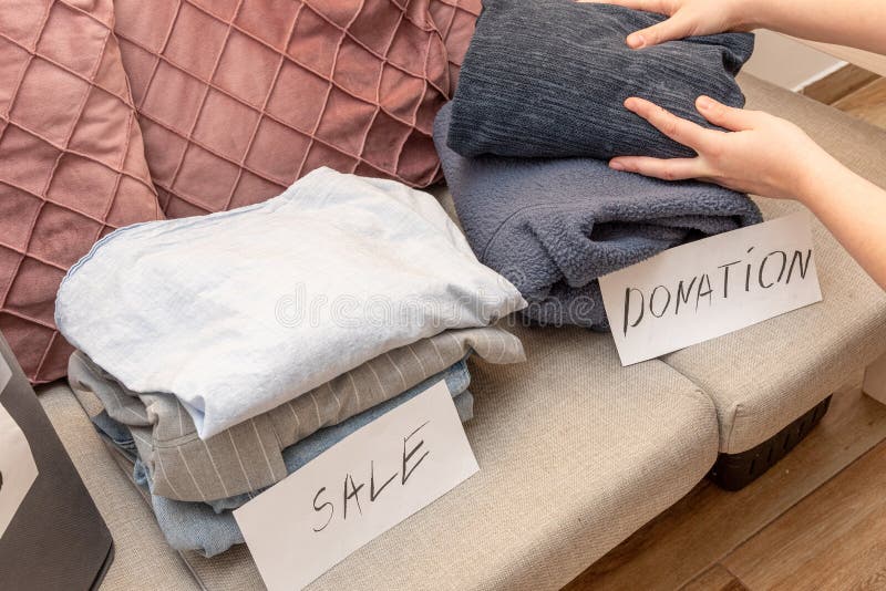 Sorting old clothes for sale, donations and rags, the concept of conscious consumption. Charity sorting stock images, royalty-free photos and pictures