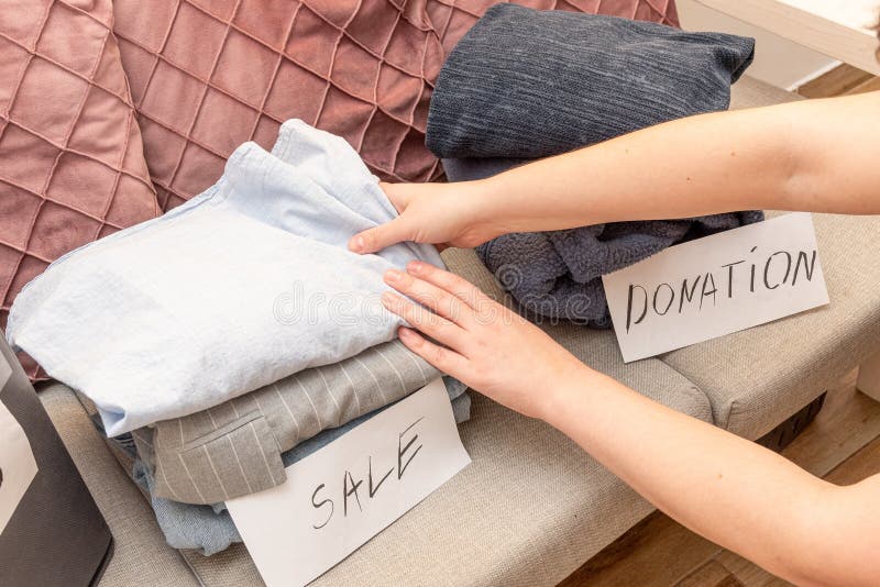 Sorting old clothes for sale, donations and rags, the concept of conscious consumption. Charity sorting stock images, royalty-free photos and pictures