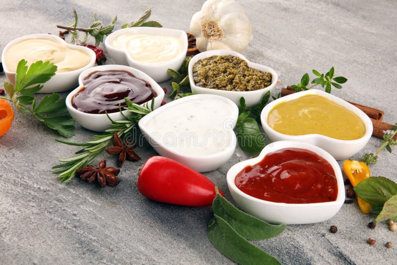 Sauces Assortment. Set of various sauces in bowls with ketchup, mayonnaise, pesto and mustard. Sauces Assortment. Set of various sauces in bowls with ketchup, mayonnaise, pesto and mustard