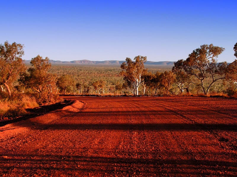 A red gravel road in Australia's Outback, found in the Karijini National Park in Western Australia. A red gravel road in Australia's Outback, found in the Karijini National Park in Western Australia