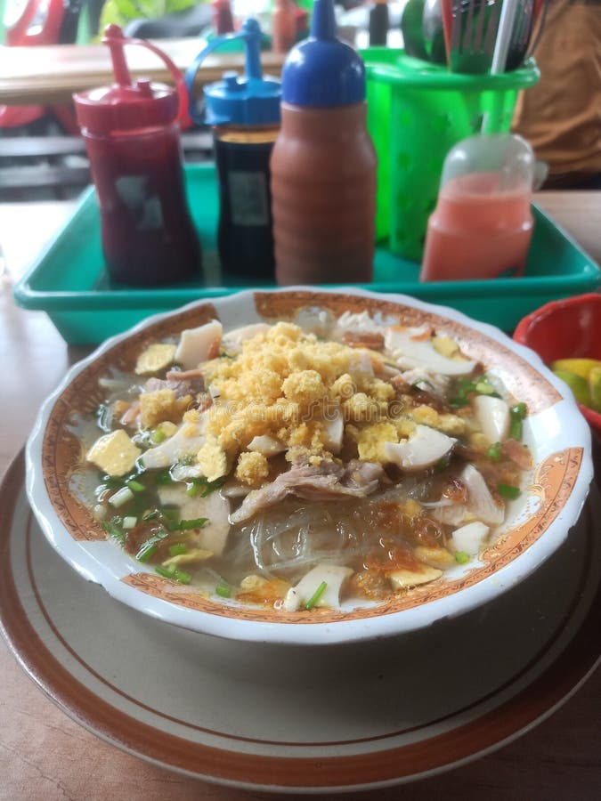 Soto Ayam Lamongan - Lamongan chicken soup with a yellowish sauce. Soto Ayam Lamongan - Lamongan chicken soup with a yellowish sauce