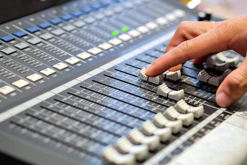 Sound engineer`s fingers are pressing the button audio controller stock photos