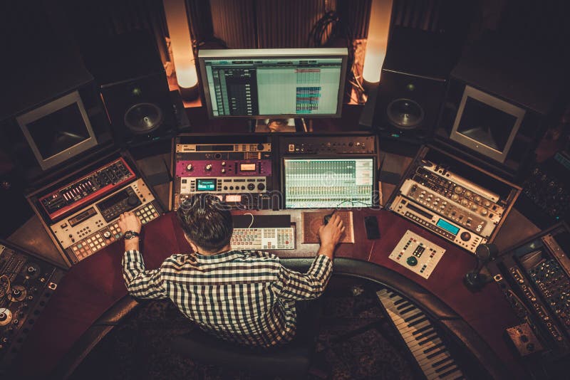 Sound engineer working in boutique recording studio. stock photography