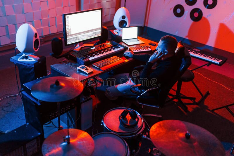 Sound Engineer Working and Mixing Music Indoors in the Studio Near Drum
