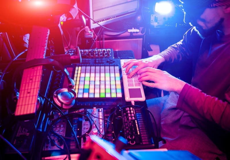 Sound engineer working at mixing panel in the in sound recording studio. Modern background