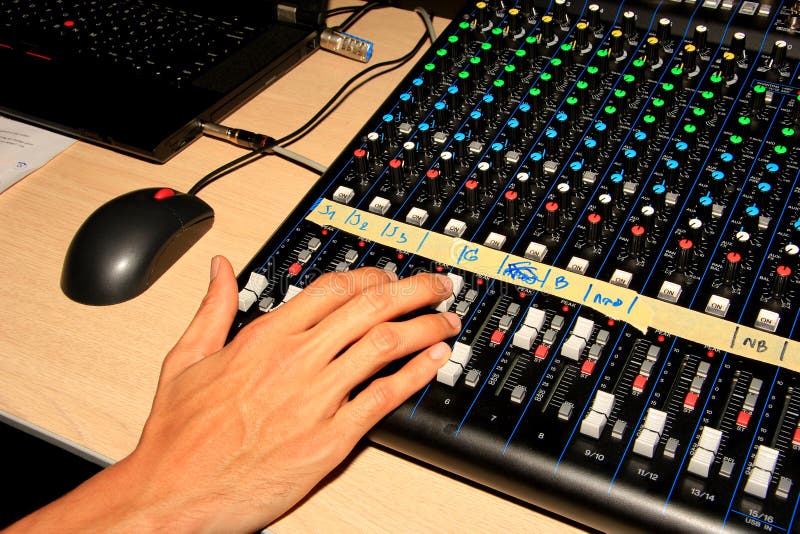 Soundman Working On The Mixing Console In Concert Hall. Stock Photo