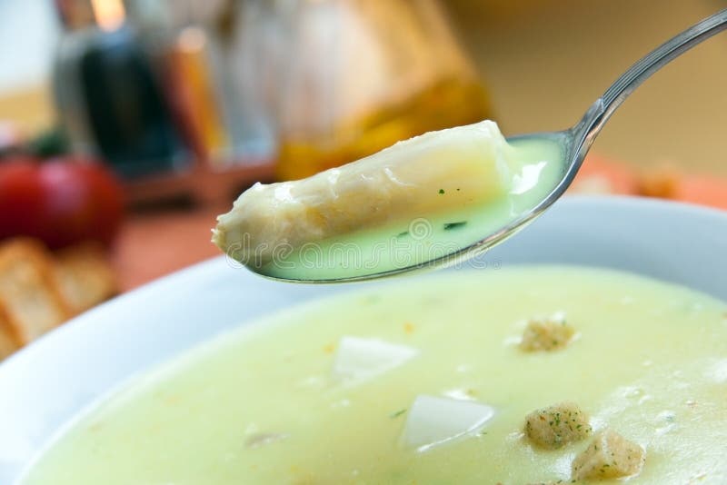 Soup of asparagus and croutons, close up